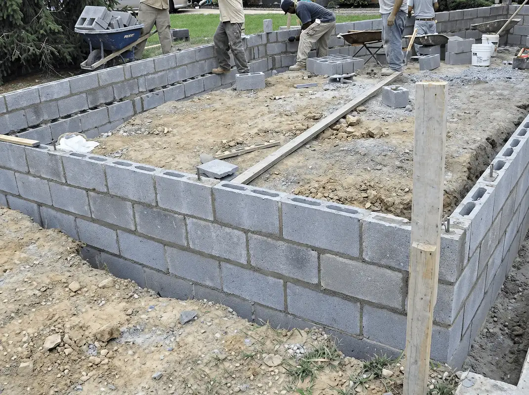 Professionals building a foundation with blocks in San Antonio, TX
